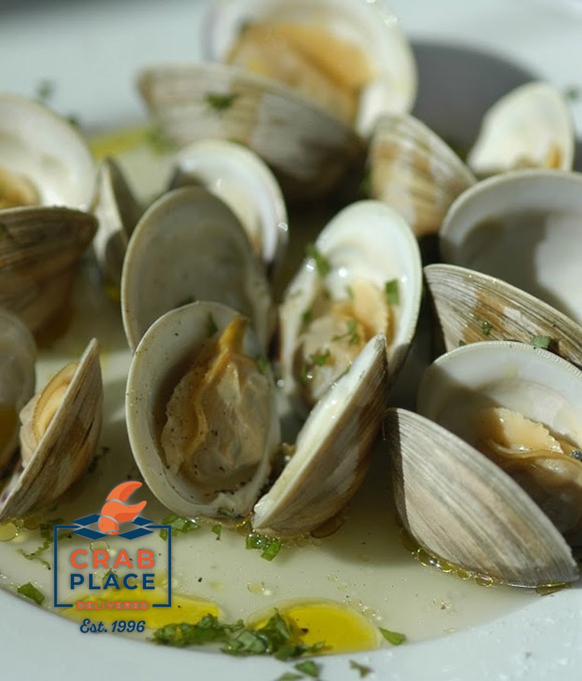Steamed Chesapeake Bay middleneck clams open in a white wine and herb broth