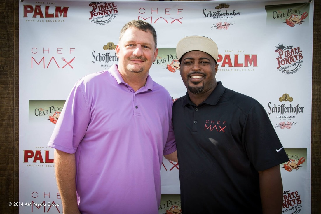 Greg Cain and Chef Max Hardy at a Chef Max and Crab Place step and repeat backdrop