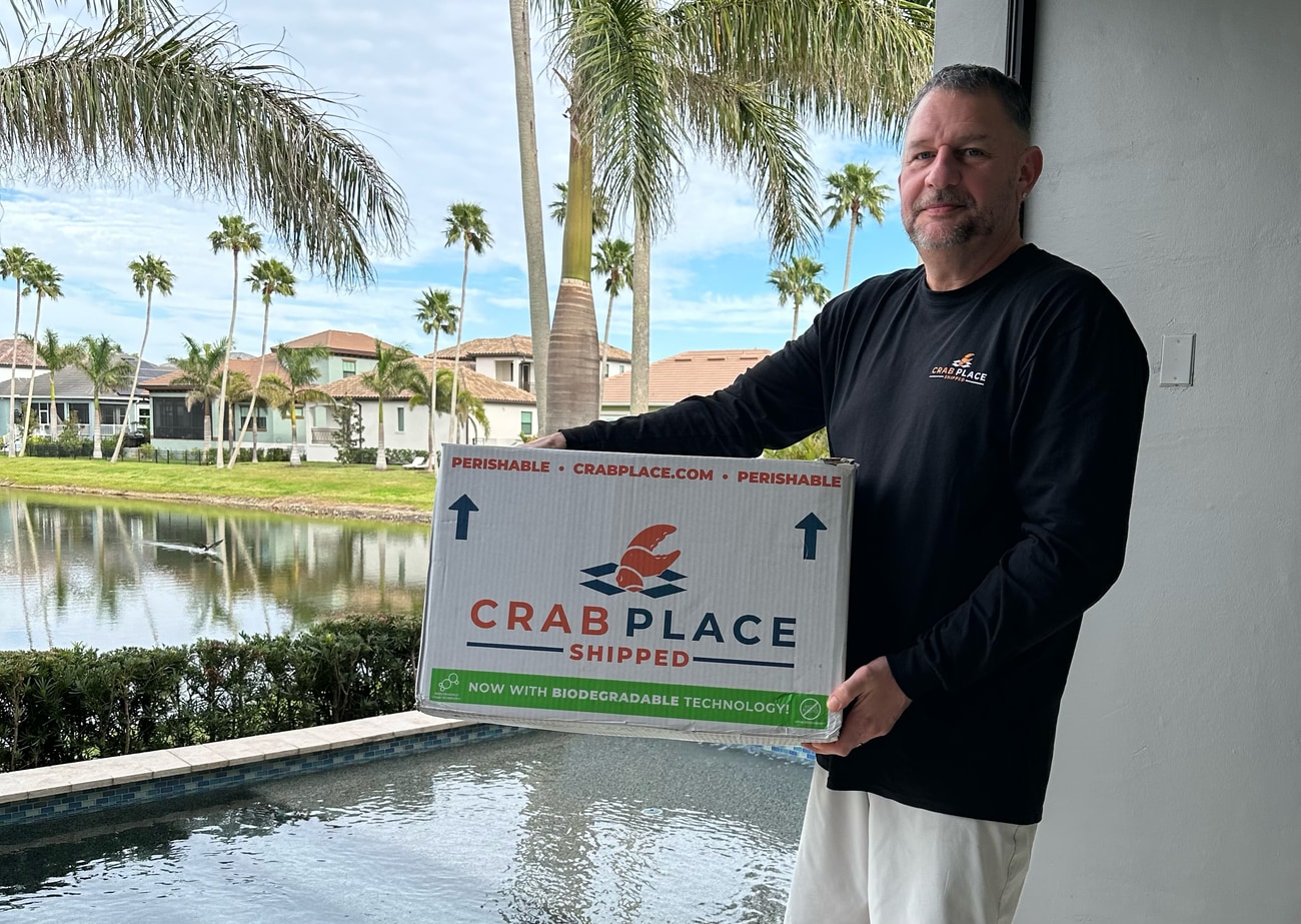 Greg Cain, founder of CrabPlace.com, holding a Crab Place shipping box