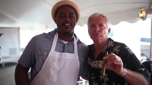 Chef Max Hardy with his arm around Dan Kuebler under the event tent in Crisfield