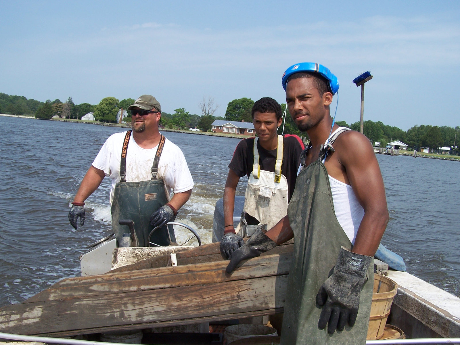 Moose Labo standing on a workboat with his two young nephews.